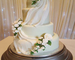3 Tier White Traditional Wedding Cake with White Roses on Green Stems