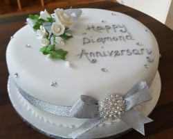 Diamond Anniversary Cake iced White with Bouquet of iced Flowers and Silver Ribbon