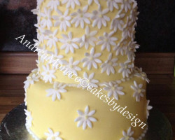Engagement cake in yellow with white daisy flowers by wedding cakes in middlesbrough