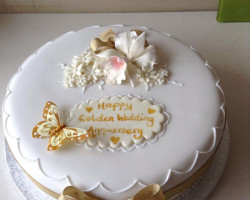Round Golden Wedding Anniversary Cake Decorated with Flowers and Gold Butterfly