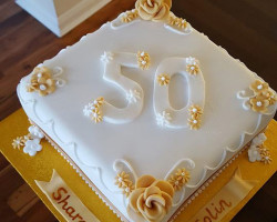 Square-White-Anniversary-Cake-with-Large-Number-50-Iced-in-Centre-and-Gold-Flowers-on-Corners-